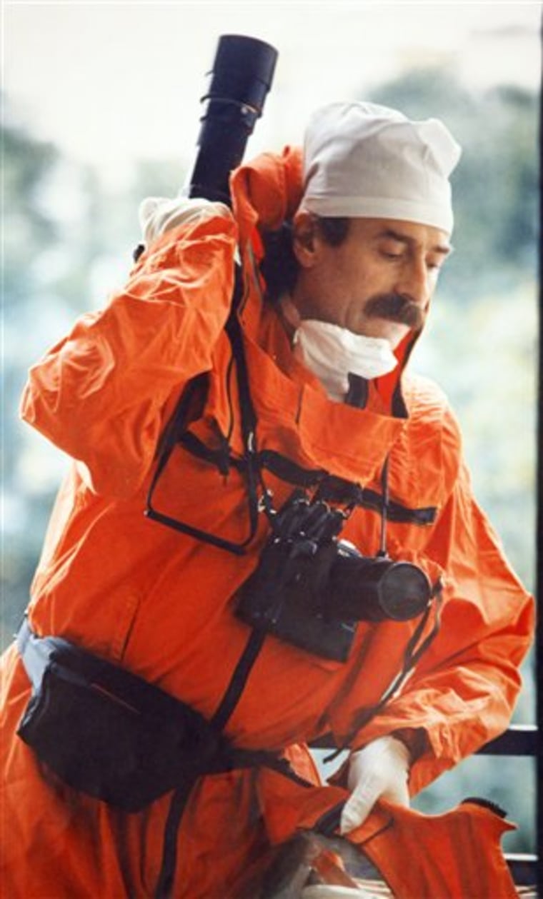 Igor Kostin taking photographs after the explosion in the 4th reactor of the Chernobyl nuclear power plant in 1986. Wearing a lead protective suit and placing his cameras in lead boxes, Kostin made a terrifying and unauthorized trip to the Chernobyl danger zone just a few days after a nuclear power plant reactor exploded in the world's worst atomic accident. He came back home with nothing to show for his determination to document the crisis — the radiation was so high that all his shots turned out black. 